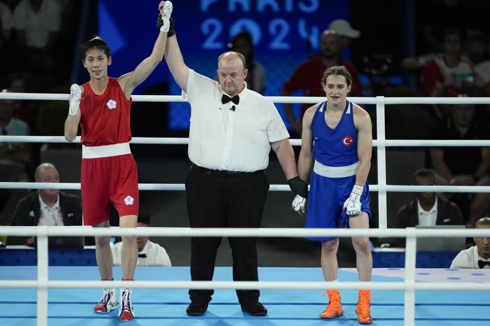 Taiwan's Lin Yu-ting, left, celebrates after defeating Turkey's Esra Yildiz in their women's 57 kg semifinal boxing match at the 2024 Summer Olympics, Wednesday, Aug. 7, 2024, in Paris, France. (AP Photo/John Locher)
