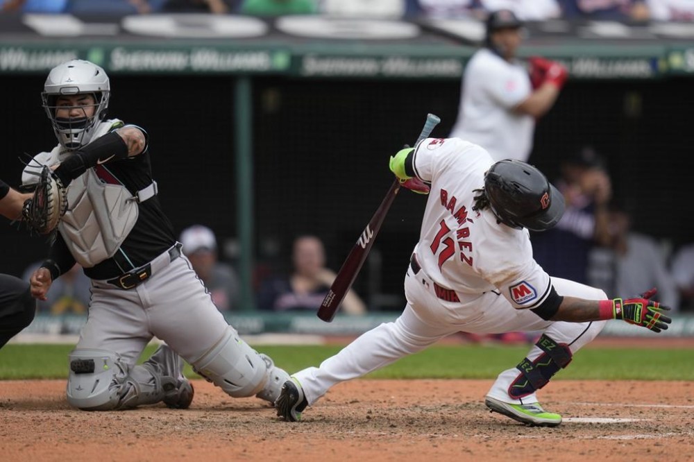 Cleveland Guardians' Jose Ramirez (11) falls away from an inside pitch as Arizona Diamondbacks catcher Jose Herrera catches the ball in the eighth inning of the first game of a baseball doubleheader in Cleveland, Wednesday, Aug. 7, 2024. (AP Photo/Sue Ogrocki)