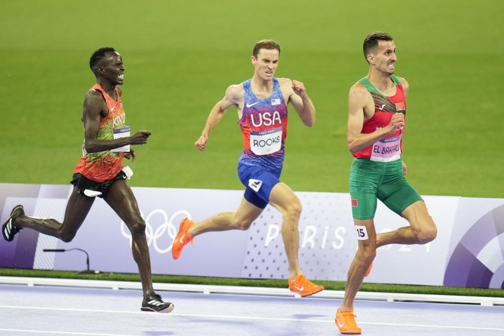 Soufiane El Bakkali, of Morocco, right, Kenneth Rooks, of the United States, center, and Abraham Kibiwot, of Kenya, competes in the men's 3000-meters steeplechase final at the 2024 Summer Olympics, Wednesday, Aug. 7, 2024, in Saint-Denis, France. (AP Photo/Natacha Pisarenko)