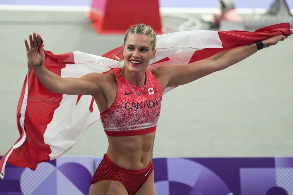 Alysha Newman, of Canada, reacts after competing in the women's pole vault final at the 2024 Summer Olympics on Wednesday, Aug. 7, 2024, in Saint-Denis, France. Newman has won Canada's first-ever Olympic medal in women's pole vault, claiming bronze with a Canadian-record height of 4.85 metres. THE CANADIAN PRESS/Christinne Muschi