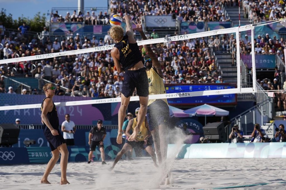 David Ahmad spikes the ball after taking a pass from teammate Jonatan Hellvig on a Swedish Jump-Set