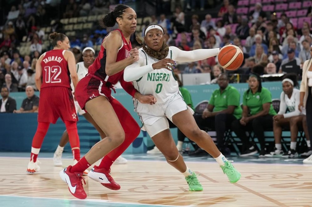 Amy Okonkwo (0), of Nigeria, drives on United States' A'ja Wilson (9) during a women's quarterfinal game at Bercy Arena at the 2024 Summer Olympics, Wednesday, Aug. 7, 2024, in Paris, France. (AP Photo/Mark J. Terrill)