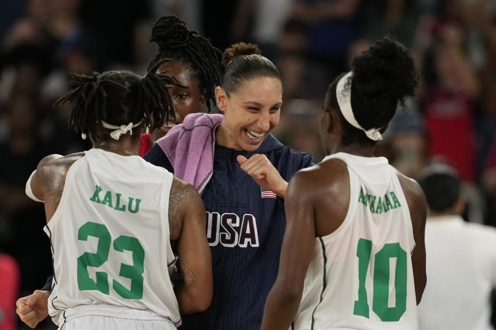 United States' Diana Taurasi (12) talks with Ezinne Kalu (23) and Promise Amukamara (10), of Nigeria, following a women's quarterfinal game at Bercy Arena at the 2024 Summer Olympics, Wednesday, Aug. 7, 2024, in Paris, France. (AP Photo/Mark J. Terrill)