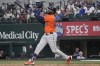 Houston Astros' Yordan Alvarez watches a fly out sail into the outfield during the 8th inning of a baseball game against the Texas Rangers in Arlington, Texas, Wednesday, Aug. 7, 2024. (AP Photo/LM Otero)