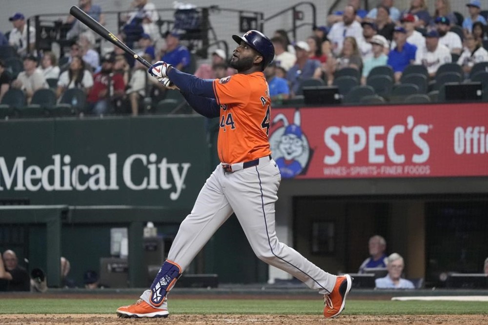 Houston Astros' Yordan Alvarez watches a fly out sail into the outfield during the 8th inning of a baseball game against the Texas Rangers in Arlington, Texas, Wednesday, Aug. 7, 2024. (AP Photo/LM Otero)
