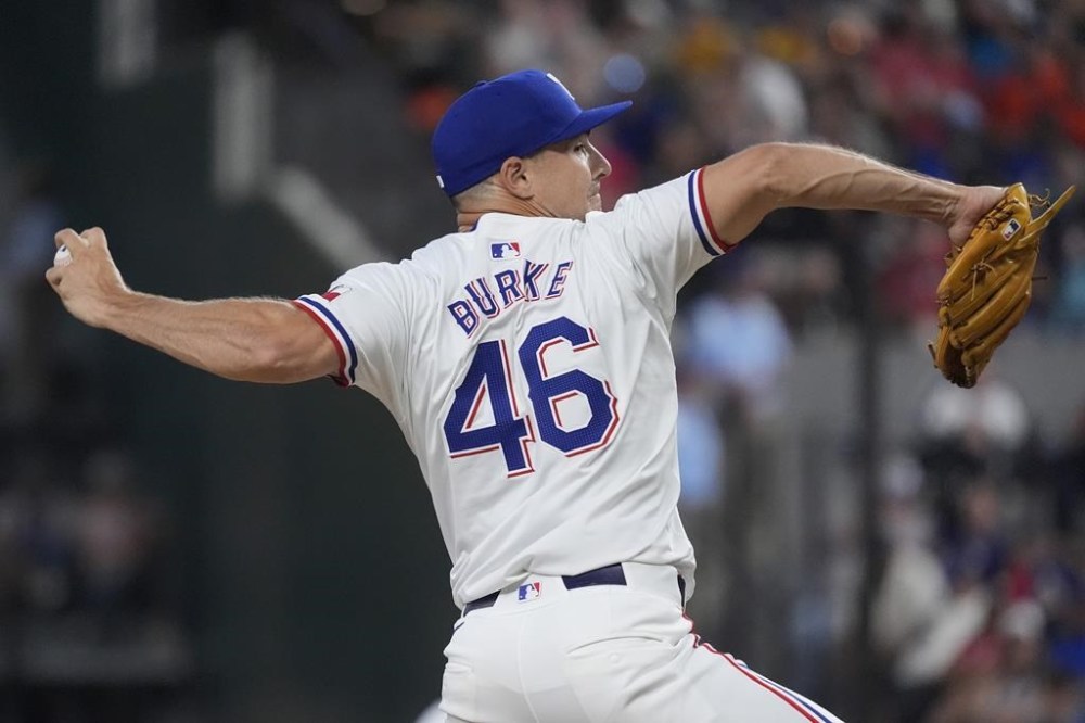 Texas Rangers pitcher Brock Burke throws during the 8th inning of a baseball game against the Houston Astros in Arlington, Texas, Wednesday, Aug. 7, 2024. (AP Photo/LM Otero)