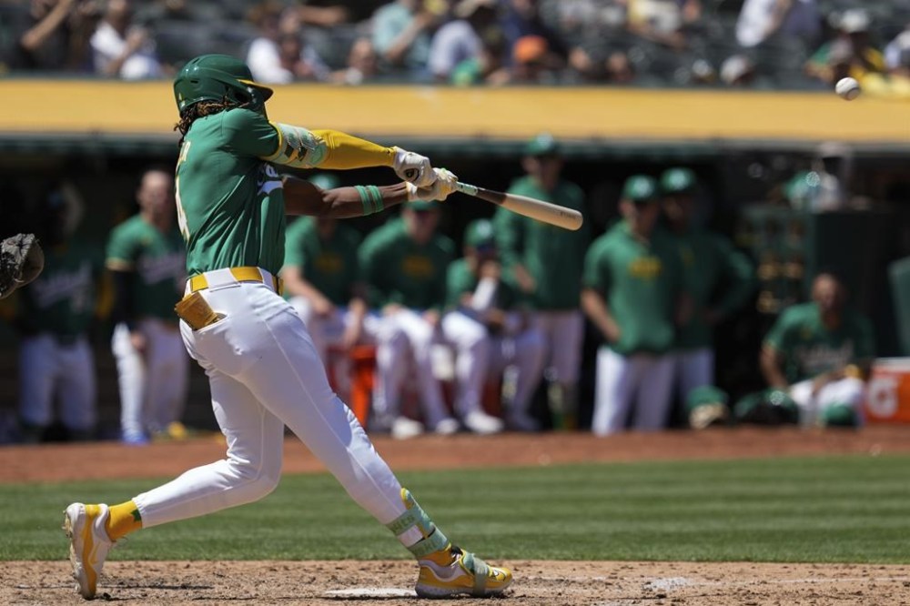 Oakland Athletics' Lawrence Butler hits a sacrifice fly against the Chicago White Sox during the seventh inning of a baseball game, Wednesday, Aug. 7, 2024, in Oakland, Calif. (AP Photo/Godofredo A. Vásquez)