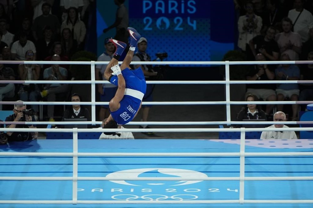 Cuba's Erislandy Alvarez Borges celebrates after defeating France's Sofiane Oumiha in their men's 63.5 kg final boxing match at the 2024 Summer Olympics, Wednesday, Aug. 7, 2024, in Paris, France. (AP Photo/John Locher)