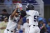 Miami Marlins' Derek Hill (58) is congratulated by Otto Lopez after Hill hit a grand slam scoring Jonah Bride, Jesús Sánchez and Lopez during the first inning of a baseball game against the Cincinnati Reds, Wednesday, Aug. 7, 2024, in Miami. (AP Photo/Wilfredo Lee)