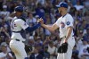 Chicago Cubs catcher Christian Bethancourt, left, celebrates with relief pitcher Julian Merryweather after the Cubs defeated the Minnesota Twins 8-2 in a baseball game in Chicago, Wednesday, Aug. 7, 2024. (AP Photo/Nam Y. Huh)