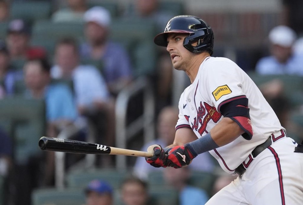 Atlanta Braves third base Austin Riley (27) drives in a run with a double in the first inning of a baseball game against the Milwaukee Brewers, Wednesday, Aug. 7, 2024, in Atlanta. (AP Photo/John Bazemore)