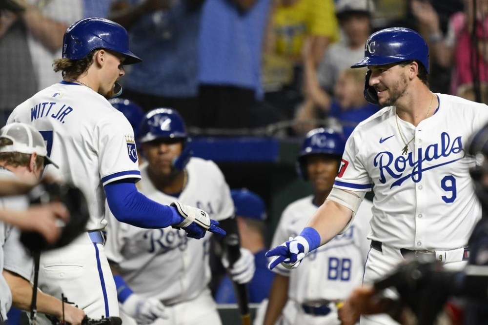 Kansas City Royals' Bobby Witt Jr., left, is congratulated by Kansas City Royals' Vinnie Pasquantino (9) after hitting a solo home run during the sixth inning of a baseball game against the Boston Red Sox, Wednesday, Aug. 7, 2024, in Kansas City, Mo. (AP Photo/Reed Hoffmann)
