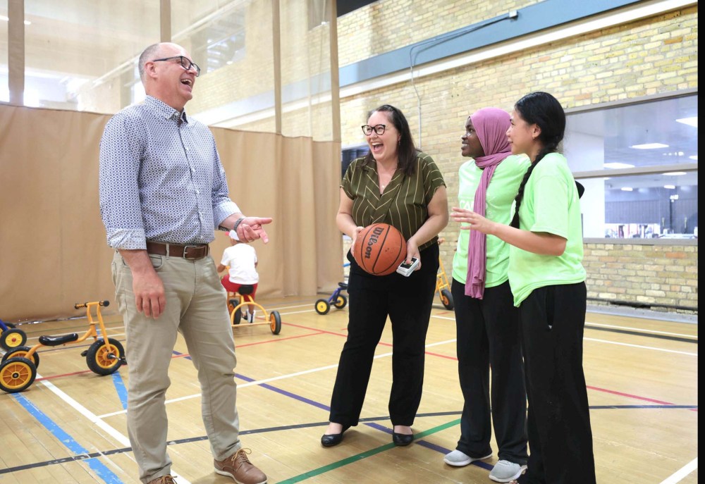 RUTH BONNEVILLE / FREE PRESS
From left: Mayor Scott Gillingham and Cordella Friesen, YWinnipeg president and CEO, with Nawal Seid and Althea Medina.