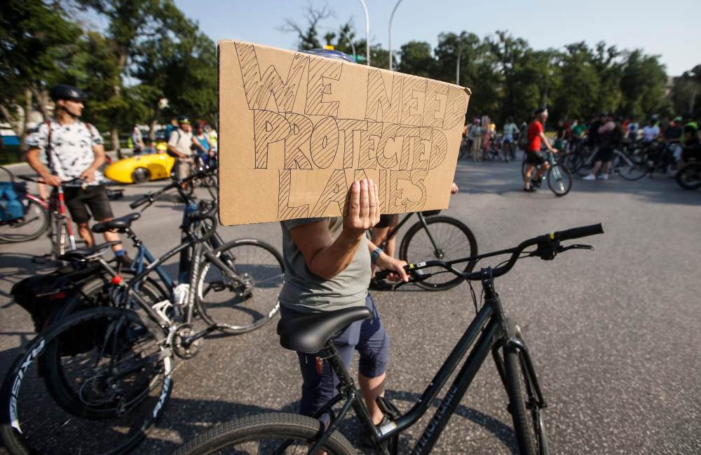 JOHN WOODS / FREE PRESS
About 180 cyclists blocked cars at the intersection of Academy and Wellington Tuesday.