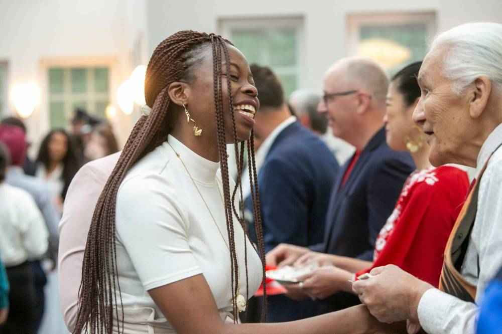 BROOK JONES / FREE PRESS
Oreo Amogu (left) is all smiles as she shakes hands with Elder Winston Wuttunee after taking the oath of citizenship.