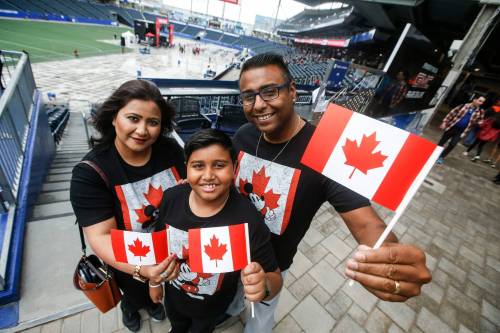 JOHN WOODS / FREE PRESS
                                Muneeba and Michael Khan with son Zion take part in the Canada Day celebrations at Princess Auto stadium Monday, July 1, 2024.