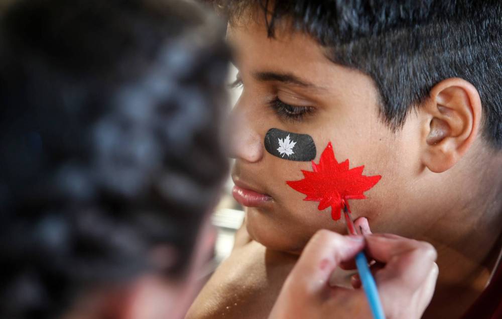 JOHN WOODS / FREE PRESS
Hritik Rajpoot has his face painted at the Canada Day celebrations at Princess Auto stadium Monday.