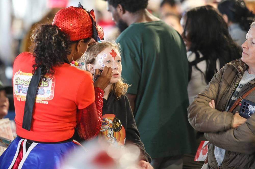 JOHN WOODS / FREE PRESS
Abby has her face painted at the Canada Day celebrations at Princess Auto stadium Monday.
