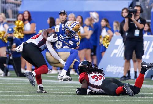 John Woods / THE CANADIAN PRESS
                                Bombers receiver Kevens Clercius is tackled by Ottawa&rsquo;s Frankie Griffin (left) and Deandre Lamont in Winnipeg&rsquo;s win on Friday.