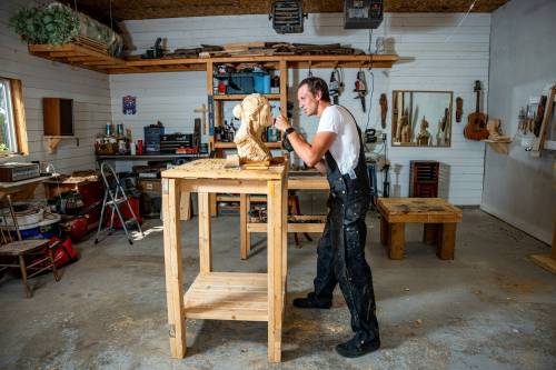 NIC ADAM / FREE PRESS
                                Carver Lucas Kost, seen here working on a bust, has been whittling wood since he was 10.