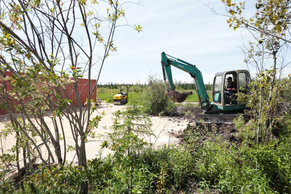 Staff prep the grounds for a new trailer to be set up that will serve as the new green room next to the main stage. (Ruth Bonneville / Free Press)