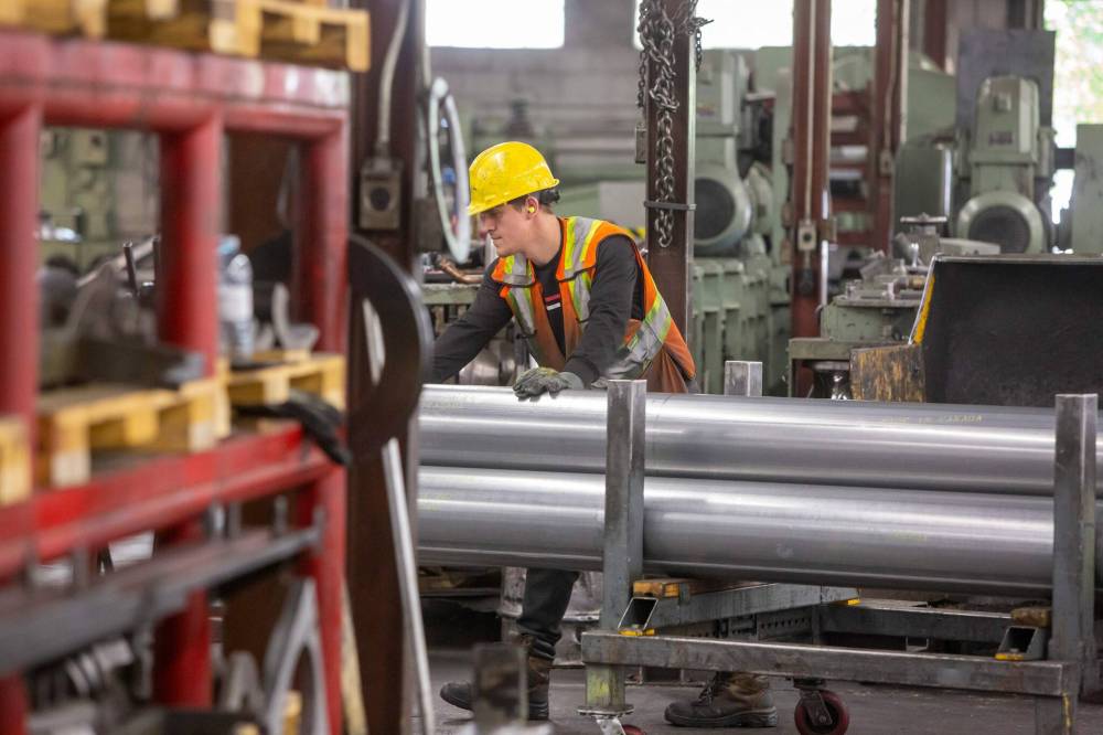 BROOK JONES / FREE PRESS
An Imperial worker moves galvanized steel tubing from the production area into the Winnipeg warehouse