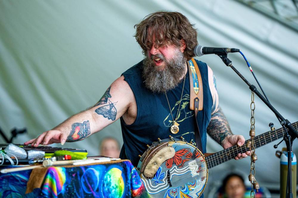 NIC ADAM / FREE PRESS
Mike Savino, who performs as Tall Tall Trees, performs at the Spruce Hollow stage at the Winnipeg Folk Festival Friday afternoon.