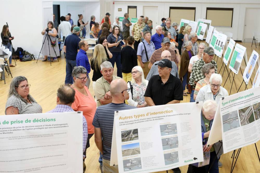 Members of the Carberry North Cypress-Langford Fire Department look over proposals during a July 2024 public open house and consultation on improvements to the intersection of the Trans-Canada Highway and Highway 5. (Tim Smith / The Brandon Sun files)