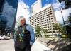 MIKAELA MACKENZIE / FREE PRESS
                                David Chartrand, president of the Manitoba Métis Federation, stands in front of the MMF’s planned property acquisition — the two Bell MTS-branded towers (and a parking lot) downtown.
