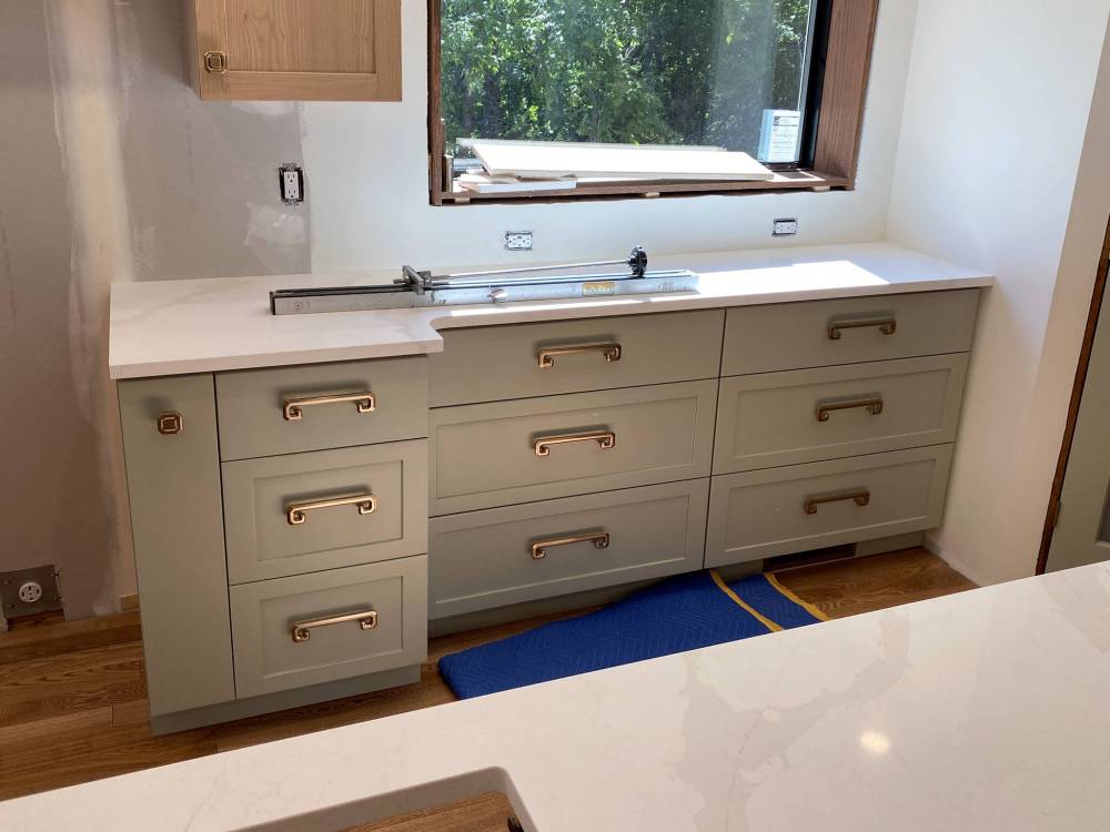 Two identical and opposite countertop wings are positioned atop the cabinets on either side of the centred stove
location. (Marc LaBossiere / Free Press)