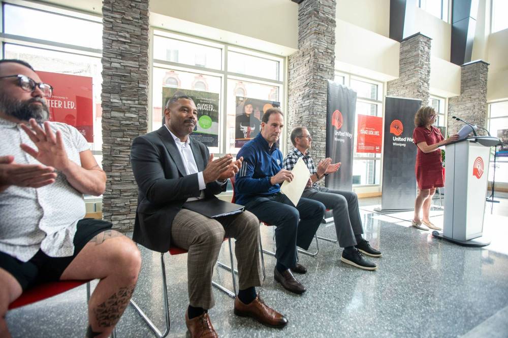 MIKAELA MACKENZIE / FREE PRESS
                                Main Street Project executive director Jamil Mahmood (left), United Way Winnipeg president and CEO Michael Richardson, Winnipeg Jets head coach Scott Arniel, True North Sports + Entertainment SVP of venues and entertainment Kevin Donnelly, and United Way Winnipeg deputy board chair Donna Miller gathered Wednesday as the $100,000 donation was announced. The money comes from proceeds of Whiteout street party ticket sales.