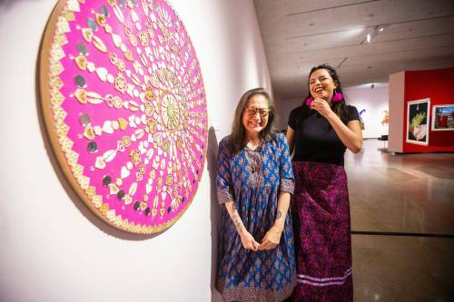 MIKAELA MACKENZIE / FREE PRESS FILES
                                Artist Lita Fontaine (left) and assistant curator Marie-Anne Redhead with Warm Heart Wheel: My Medicine Series.