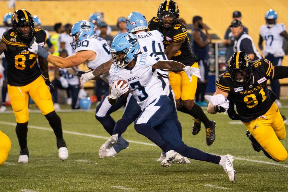 Peter Power / THE CANADIAN PRESS
The Argonauts’ Janarion Grant scores on a kick-off return against the Hamilton Tiger-Cats.