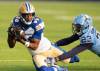 Bombers wide receiver Ontaria Wilson (80) makes a catch in front of Argonauts defensive back Benjie Franklin (23). THE CANADIAN PRESS/Frank Gunn