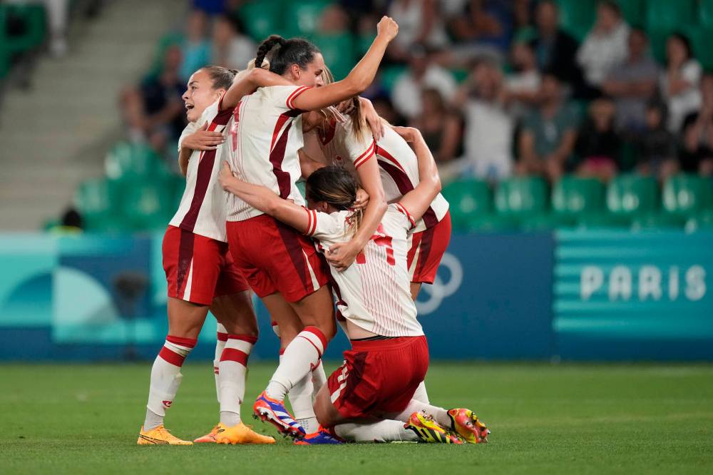 SILVIA IZQUIERDO / THE ASSOCIATED PRESS
Canada team celebrates their side’s 2-1 win at the end of the women’s Group A soccer match between Canada and France at Geoffroy-Guichard stadium during the 2024 Summer Olympics, Sunday in Saint-Etienne, France.