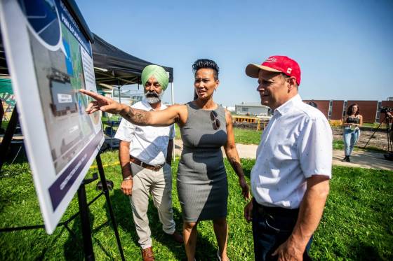 Diljeet Brar, MLA for Burrows (left), Vivian Santos, chairperson of the Standing Policy Committee on Community Services, and Kevin Lamoureux, MP for Winnipeg North, look at plans for the new basketball court and playground at Northwood Community Centre. (Mikaela MacKenzie / Free Press)