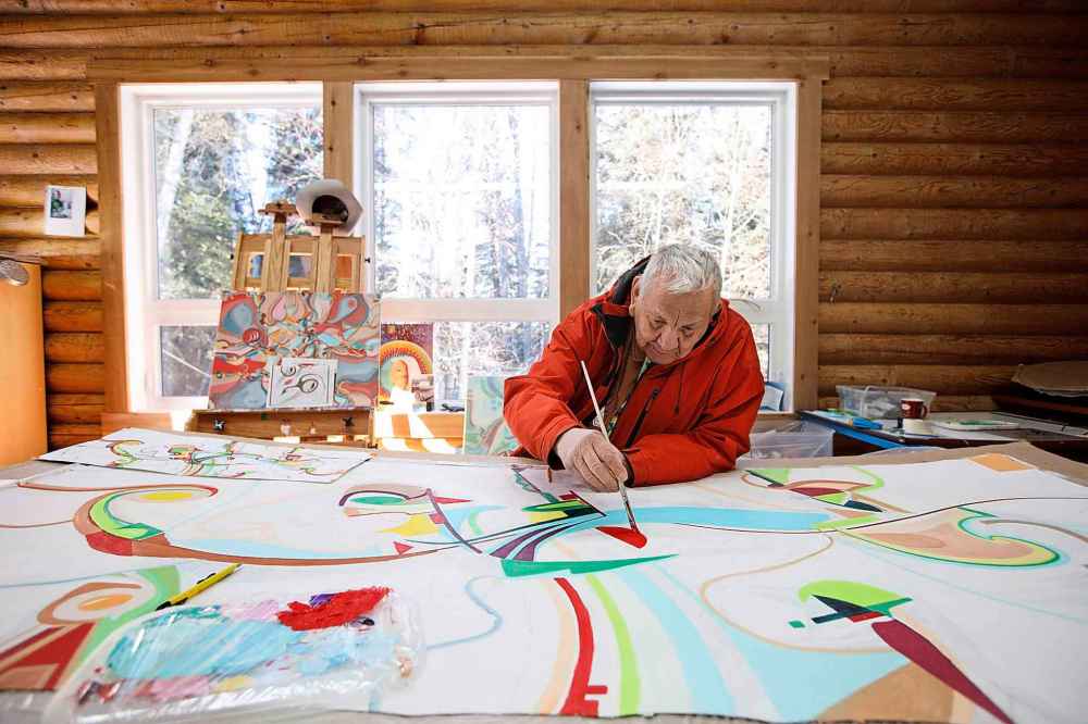 Jason Franson / The Canadian Press Files 
Alex Janvier works at his studio in Cold Lake First Nations in 2017.