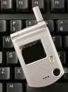 A C3 flip phone from Pantech is shown, on a keyboard for size comparison, Thursday, March 8, 2007 in New York. The compact, minimalist style of the C3, available in the United States through AT&T's Cingular Wireless, always manages to draw reaction. (AP Photo/Mark Lennihan)