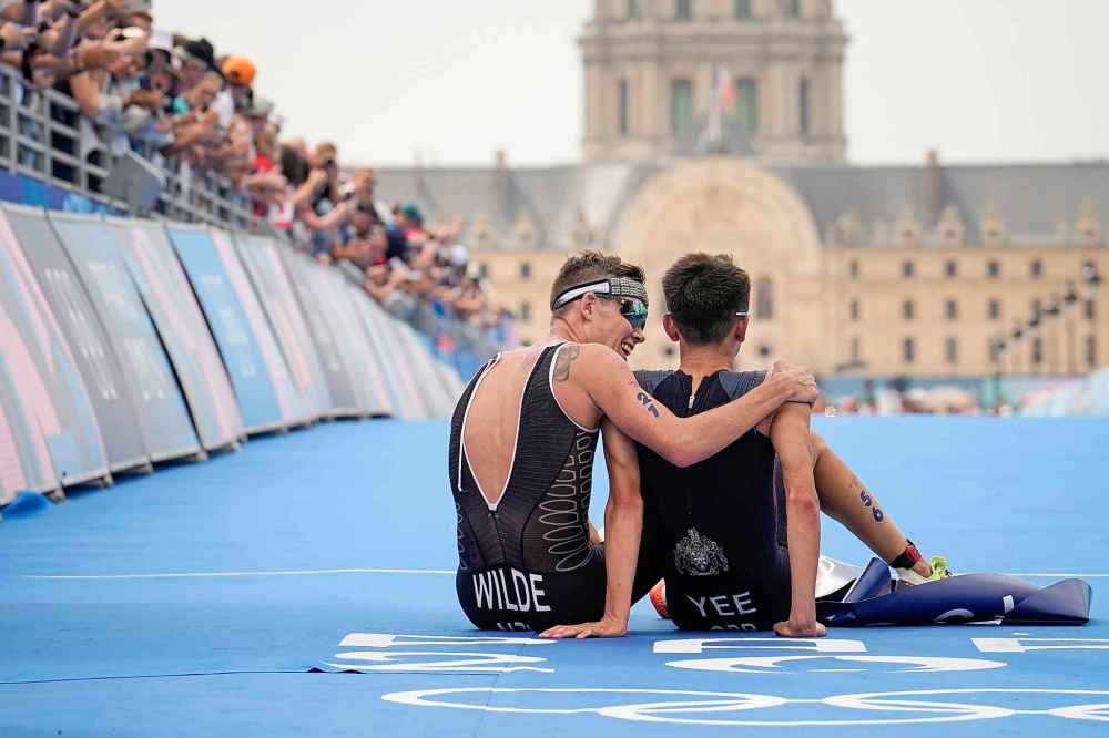Vadim Ghirda / The Associated PressNew Zealand's Hayden Wilde, left, winner of the silver medal hugs Britain's Alex Yee, right, winner of the gold medal at the end of the men's individual triathlon competition. (AP Photo/Vadim Ghirda)