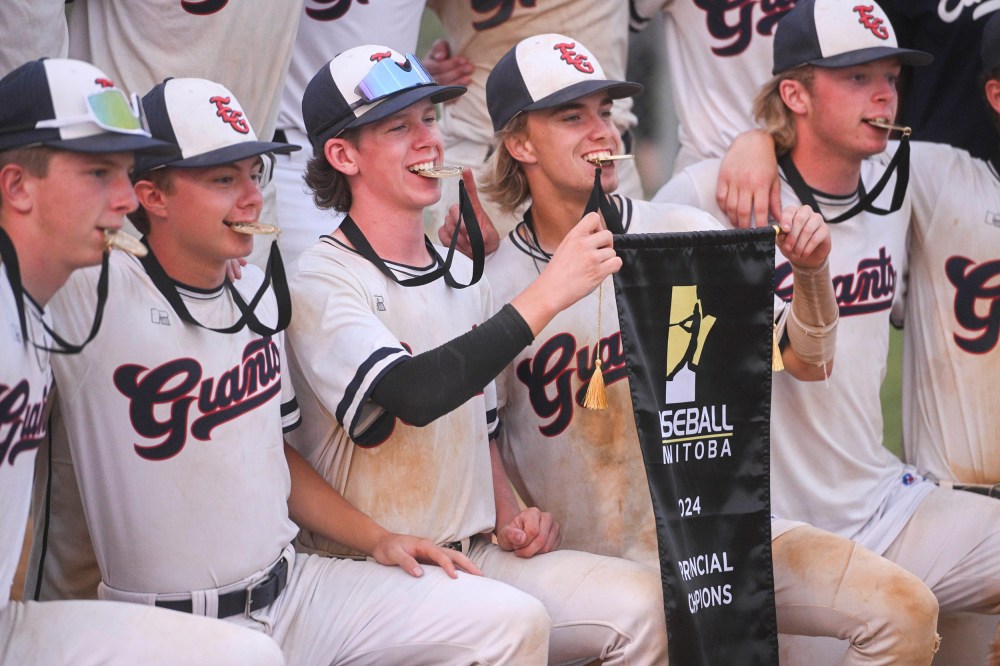 The Giants share a moment with their 1st place medals and banner after winning the AAA Baseball Manitoba Provincial Championships. (Mike Sudoma / Free Press)