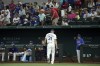 Texas Rangers starting pitcher Max Scherzer (31) leaves the field as pitching coach Mike Maddux, right, look on after Scherzer gave up 4 runs in the second inning of a baseball game Saturday, July 20, 2024, in Arlington, Texas. Scherzer did not return. (AP Photo/Jeffrey McWhorter)