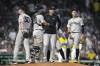 New York Yankees manager Aaron Boone, center right, stands on the mound after relieving Michael Tonkin (50) during the seventh inning of a baseball game against the Boston Red Sox, Saturday, July 27, 2024, in Boston. (AP Photo/Michael Dwyer)