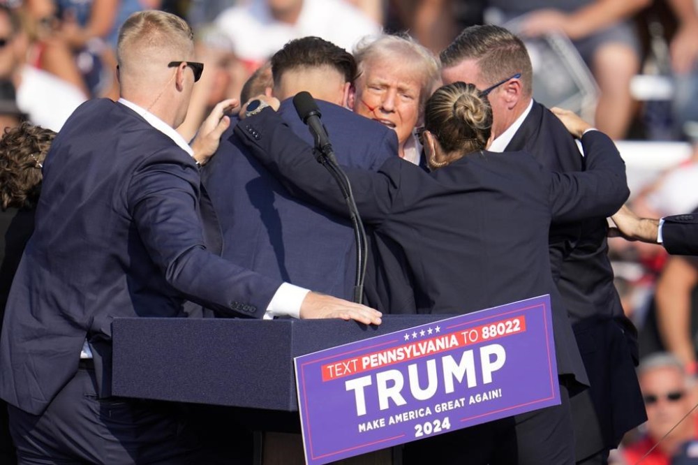 FILE - Republican presidential candidate former President Donald Trump is surrounded by Secret Service at a campaign event in Butler, Pa., July 13, 2024. Few Americans have high confidence in the Secret Service's ability to keep presidential candidates safe after last month's attempt on Trump's life. That is according to a new poll conducted July 25-29, 2024, from the AP-NORC Center for Public Affairs Research. Only around three in 10 Americans are extremely or very confident that the Secret Service can keep the presidential candidates safe from violence before the election. (AP Photo/Gene J. Puskar, File)