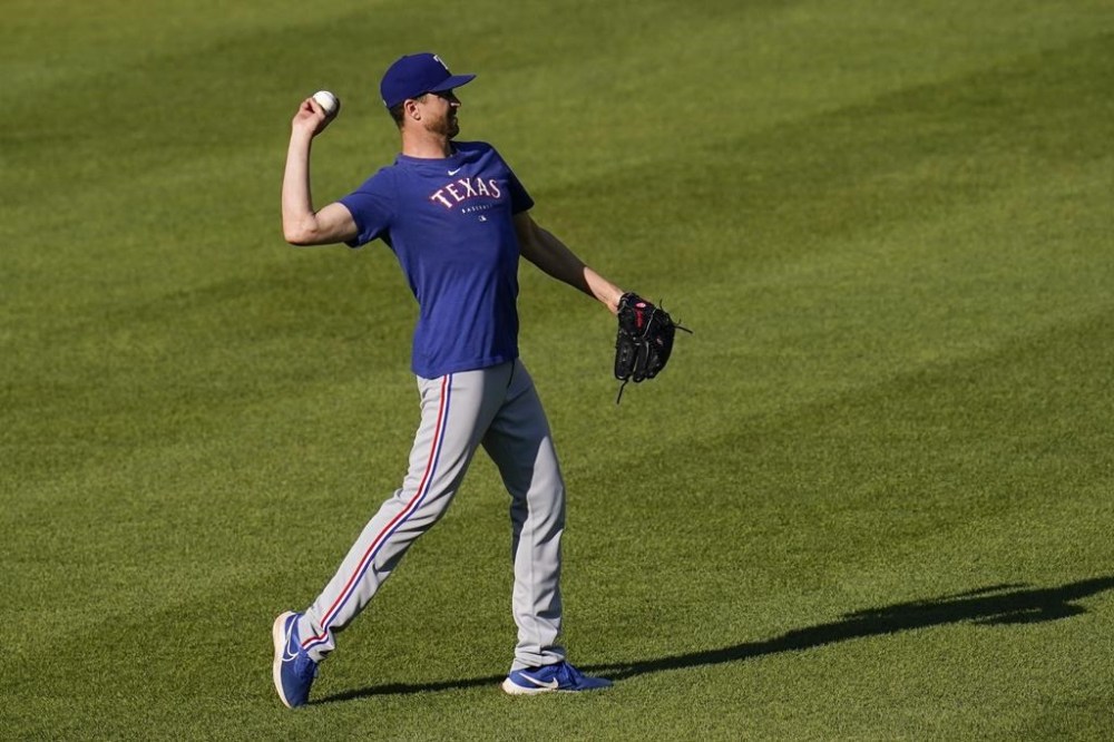 FILE - Texas Rangers pitcher Jacob deGrom works out prior to a baseball game against the Baltimore Orioles, in Baltimore, May 26, 2023. (AP Photo/Julio Cortez, File)