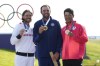Gold medalist Scottie Scheffler, of the United States, centre, with Tommy Fleetwood, of Britain, silver medal, and Hideki Matsuyama, of Japan, with the bronze medal pose for the media following the medal ceremony for men's golf at the 2024 Summer Olympics, Sunday, Aug. 4, 2024, at Le Golf National in Saint-Quentin-en-Yvelines, France. (AP Photo/Matt York)