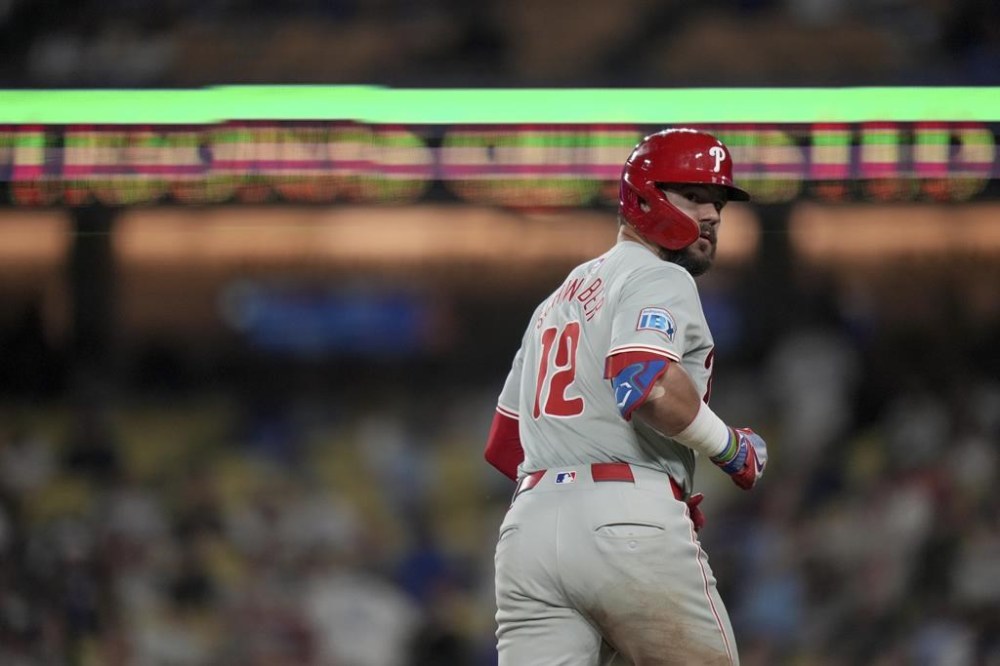 Philadelphia Phillies designated hitter Kyle Schwarber stares at the Los Angeles Dodgers bench after hitting a home run during the ninth inning of a baseball game in Los Angeles, Wednesday, Aug. 7, 2024. (AP Photo/Eric Thayer)