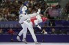 Bulgaria's Kimia Alizadeh Zenozi competes with Iran's Nahid Kiyanichandeh in a women's 57kg Taekwondo match during the 2024 Summer Olympics, at the Grand Palais, Thursday, Aug. 8, 2024, in Paris, France. (AP Photo/Andrew Medichini)