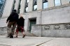 People pass the Bank of Canada in Ottawa, on Wednesday, July 24, 2024. The Bank of Canada has named three experts that will assess its internal review of the central bank's policy response to the COVID-19 pandemic. THE CANADIAN PRESS/Justin Tang
