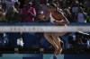Canada's Brandie Wilkerson celebrates victory in the women's semi-final beach volleyball match between Switzerland and Canada at Eiffel Tower Stadium at the 2024 Summer Olympics, Thursday, Aug. 8, 2024, in Paris, France. (AP Photo/Louise Delmotte)