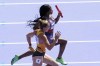 Sha'carri Richardson, of the United States, and Rebekka Haase, of Germany, compete in a women's 4 x 100 meters relay round 1 heat at the 2024 Summer Olympics, Thursday, Aug. 8, 2024, in Saint-Denis, France. (AP Photo/Martin Meissner)